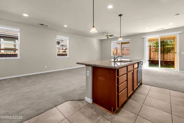 a kitchen with stainless steel appliances granite countertop a sink and a stove