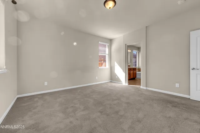 an empty room with an empty space and windows