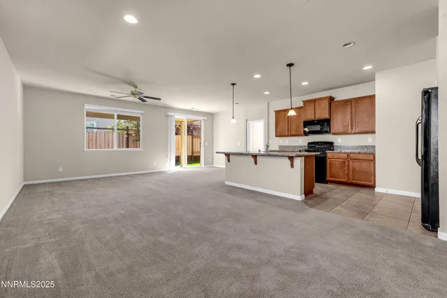 a view of a kitchen with a sink and a refrigerator