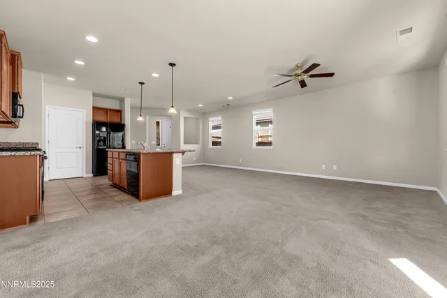 a view of a kitchen with furniture and a ceiling fan