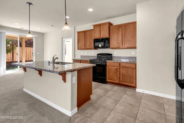 a kitchen with stainless steel appliances granite countertop a stove top oven a sink a counter top space and cabinets