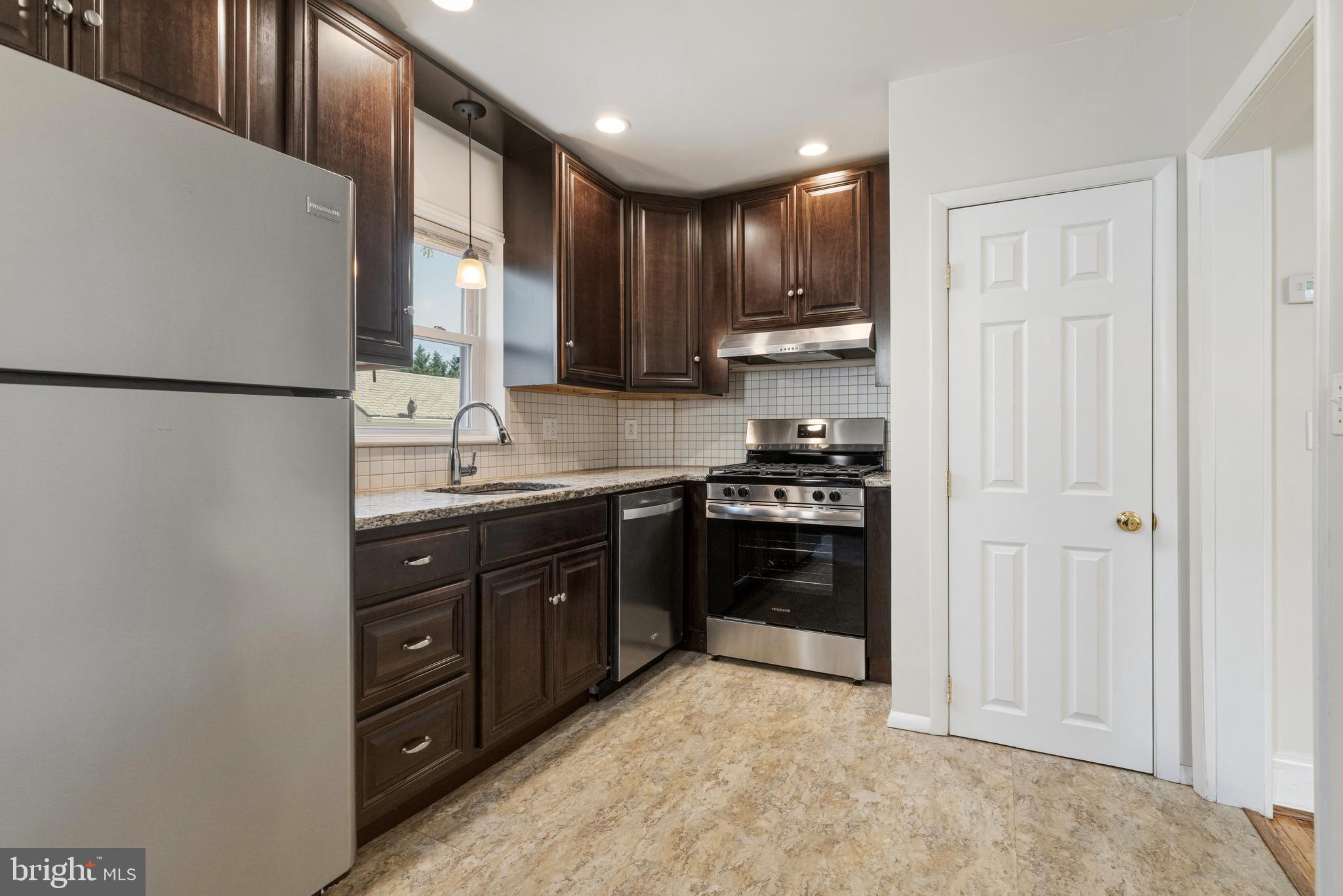 229 Wayne Avenue Narberth, PA 19072 - Photo 15 of 35 a kitchen with stainless steel appliances granite countertop a refrigerator stove and sink