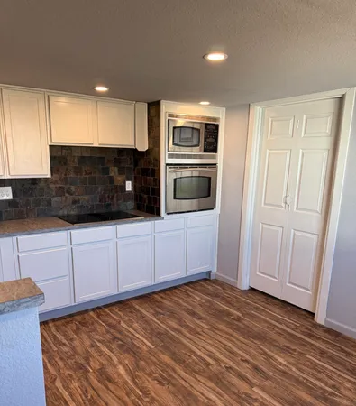 a view of a kitchen with electric appliances