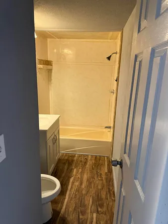 a bathroom with a granite countertop sink toilet and shower