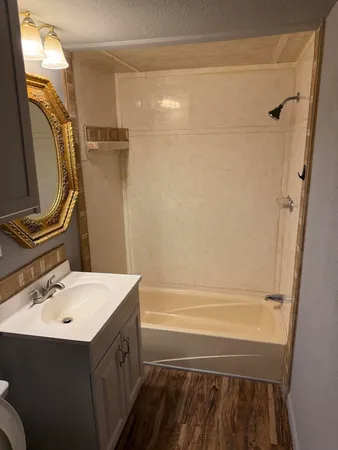 a bathroom with a sink mirror vanity and toilet