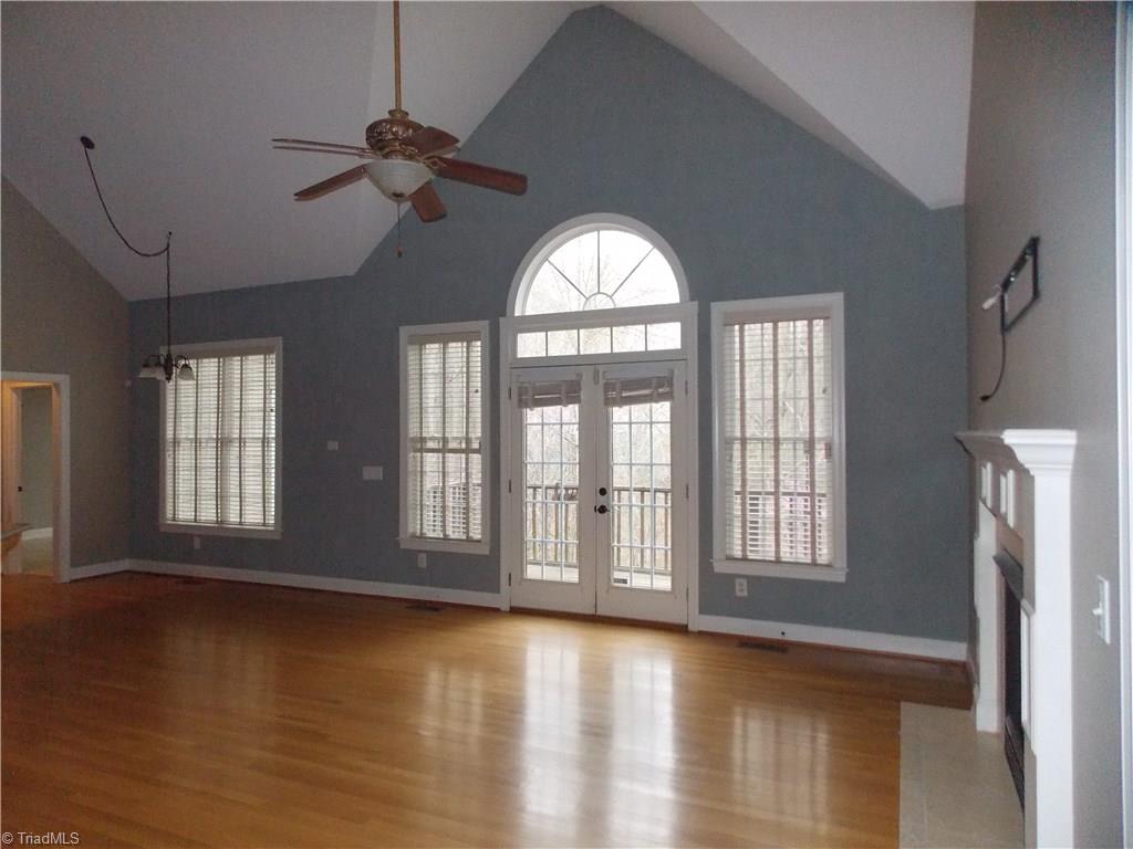 7802 Perthshire Drive Oak Ridge, NC 27310 - Photo 5 of 30 Great room with hard wood floors, vaulted ceilings, fireplace.