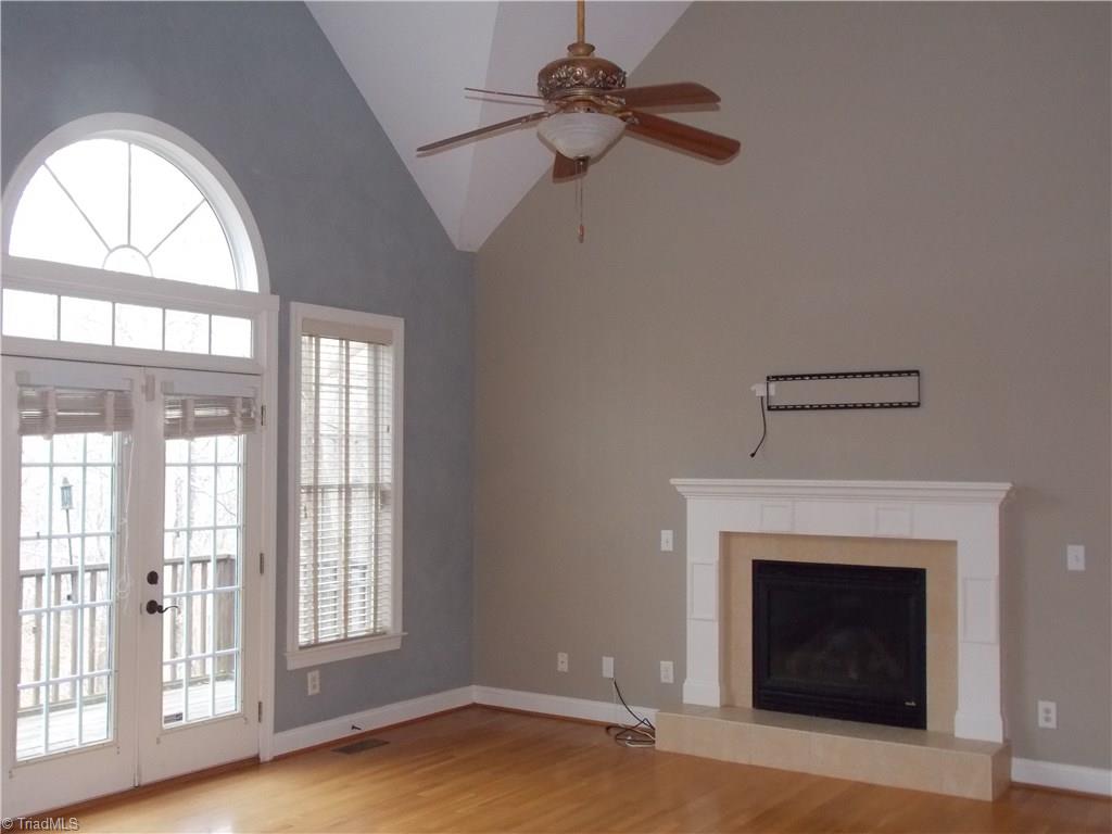 7802 Perthshire Drive Oak Ridge, NC 27310 - Photo 6 of 30 Great room has plenty of natural light and doorway to the deck overlooking private wooded area