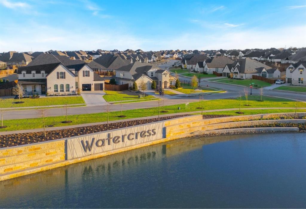 566 Broadleaf Way Haslet, TX 76052 - Photo 7 of 38 This property is located within a community featuring a welcoming entrance statement and a tranquil body of water