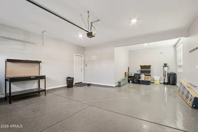 a view of a room with gym equipment and a view of living room