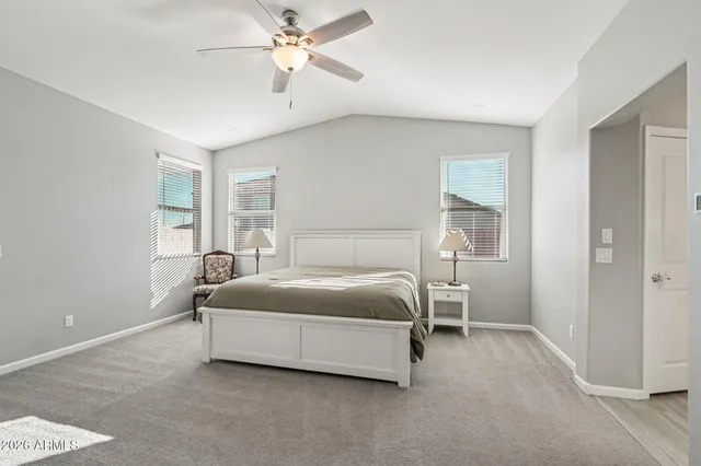 a spacious bedroom with a bed and window