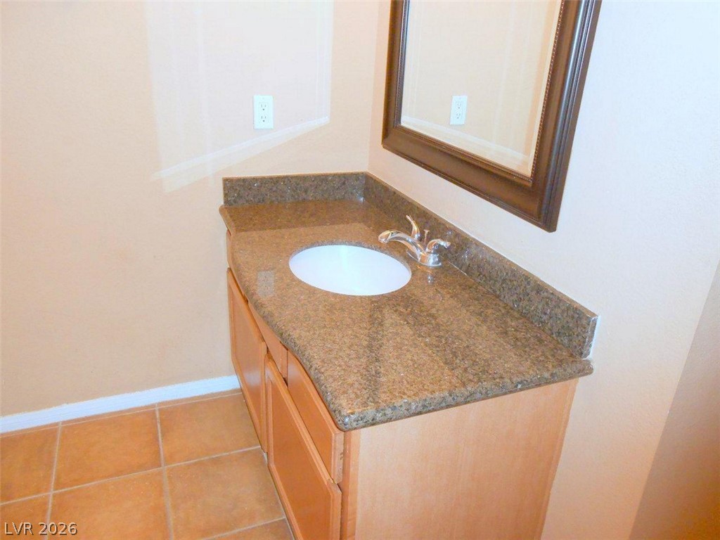 9325 West Desert Inn Road, Unit 132 Las Vegas, NV 89117 - Photo 17 of 36 A sleek vanity with granite counters and a clean basin offers functional style.