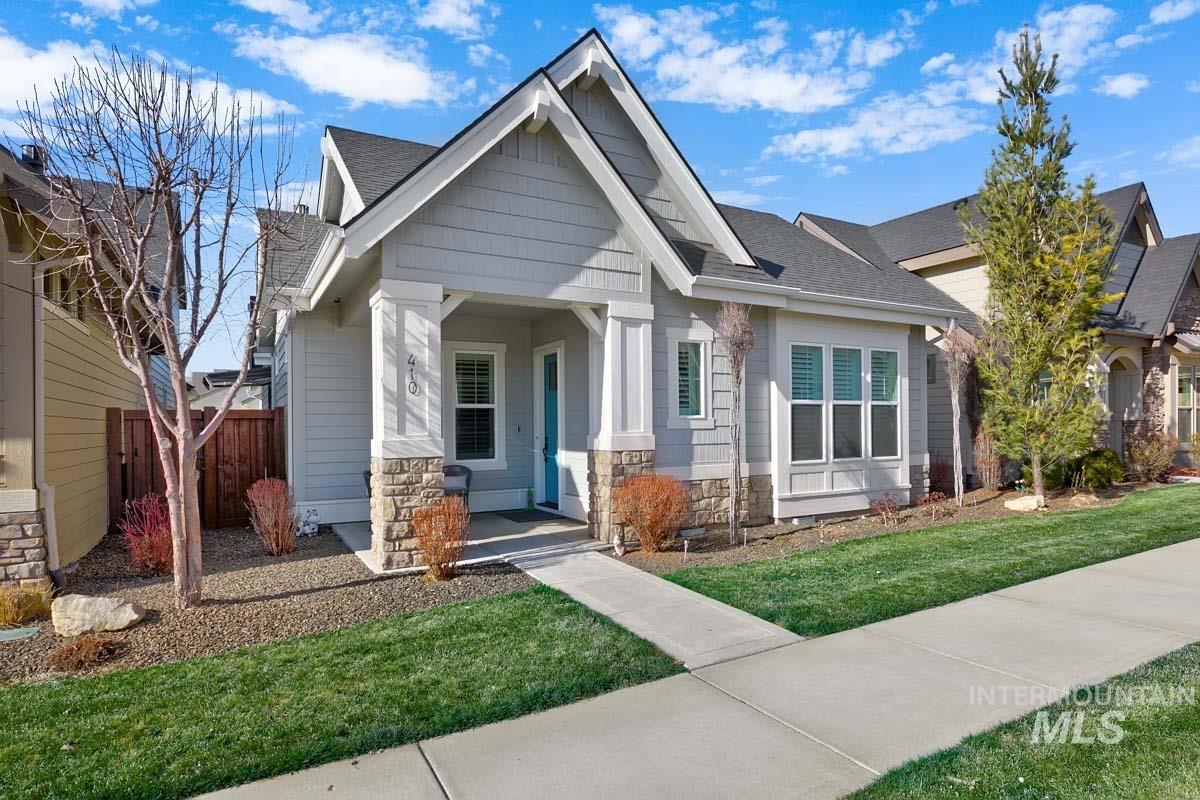 Craftsman inspired home featuring stone siding, a shingled roof, and a porch