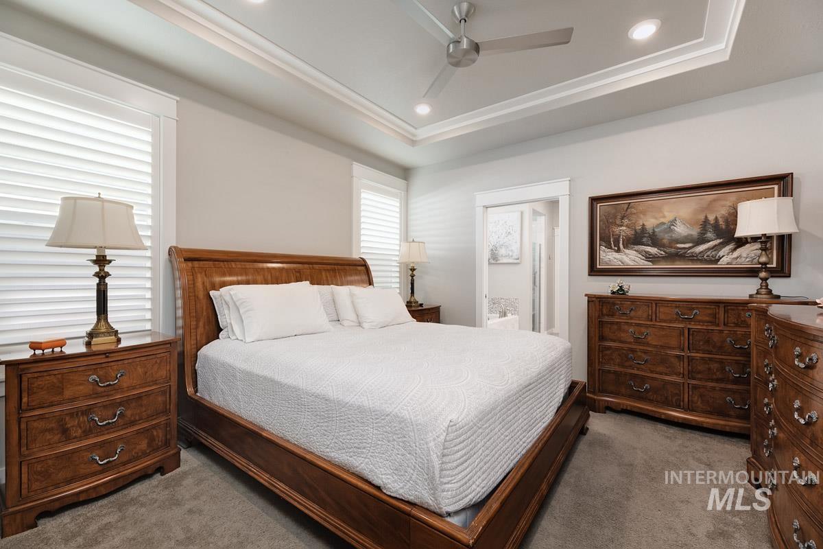 410 West Lockhart Lane Meridian, ID 83646 - Photo 19 of 41 Carpeted bedroom featuring ceiling fan, recessed lighting, ensuite bath, and a tray ceiling