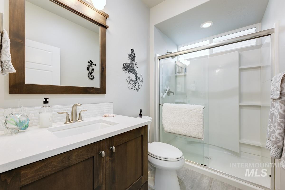 410 West Lockhart Lane Meridian, ID 83646 - Photo 22 of 41 Bathroom featuring a shower stall, vanity, recessed lighting, and decorative backsplash