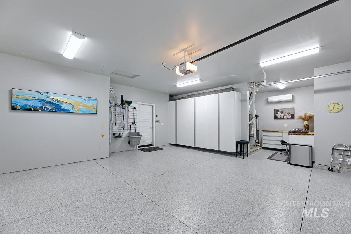 410 West Lockhart Lane Meridian, ID 83646 - Photo 27 of 41 Garage featuring a wall mounted mini split and a garage door opener