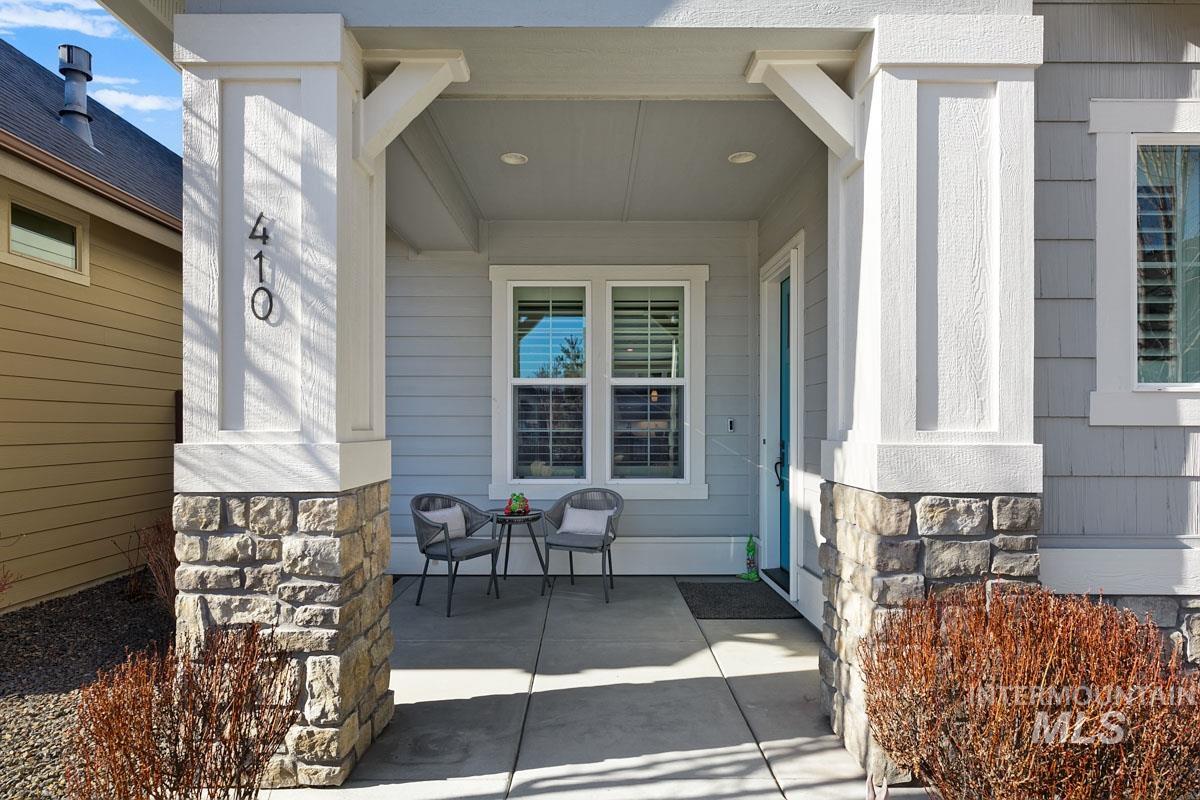 410 West Lockhart Lane Meridian, ID 83646 - Photo 3 of 41 Doorway to property with stone siding and covered porch