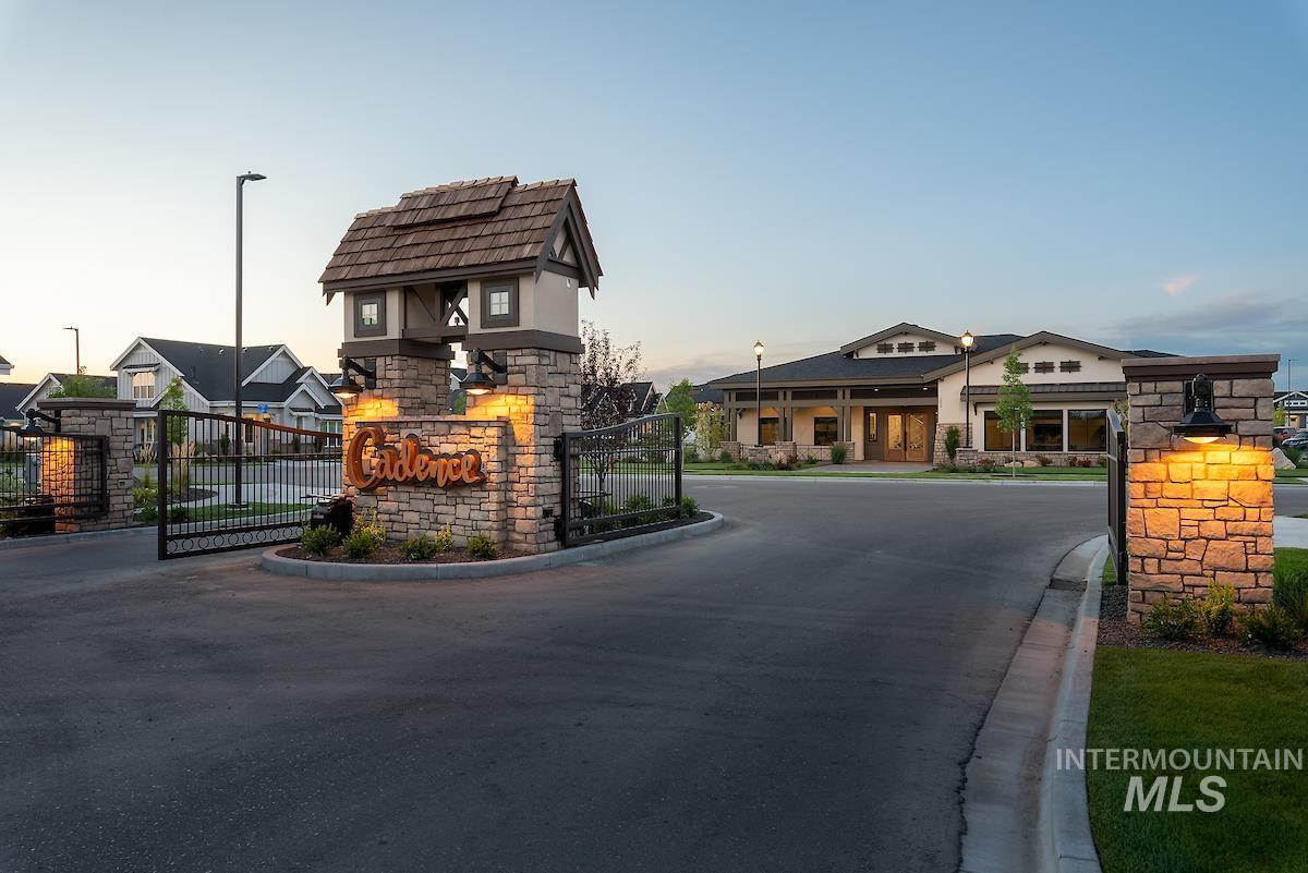 410 West Lockhart Lane Meridian, ID 83646 - Photo 32 of 41 View of asphalt road featuring a gated entry, street lights, a gate, curbs, and a residential view