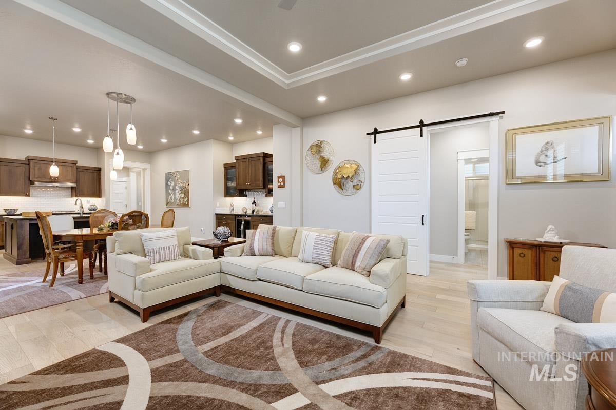 410 West Lockhart Lane Meridian, ID 83646 - Photo 7 of 41 Living area featuring a barn door, light wood-type flooring, and recessed lighting