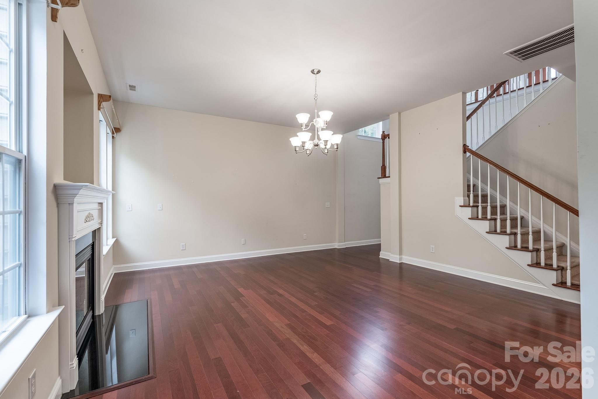 878 Treasure Court Fort Mill, SC 29708 - Photo 9 of 48 a view of a livingroom with wooden floor and staircase