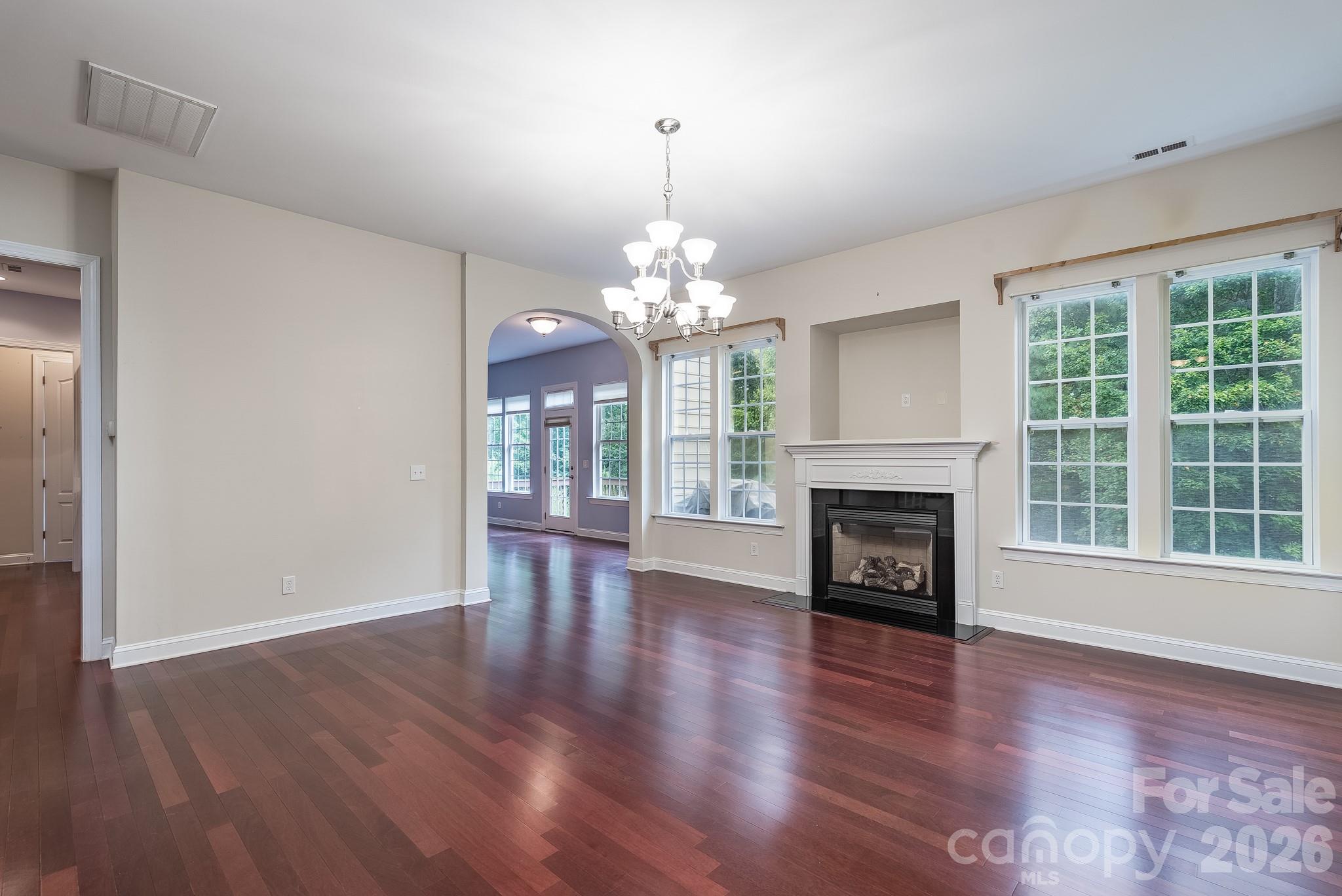 878 Treasure Court Fort Mill, SC 29708 - Photo 10 of 48 a view of a livingroom with window fireplace and wooden floor