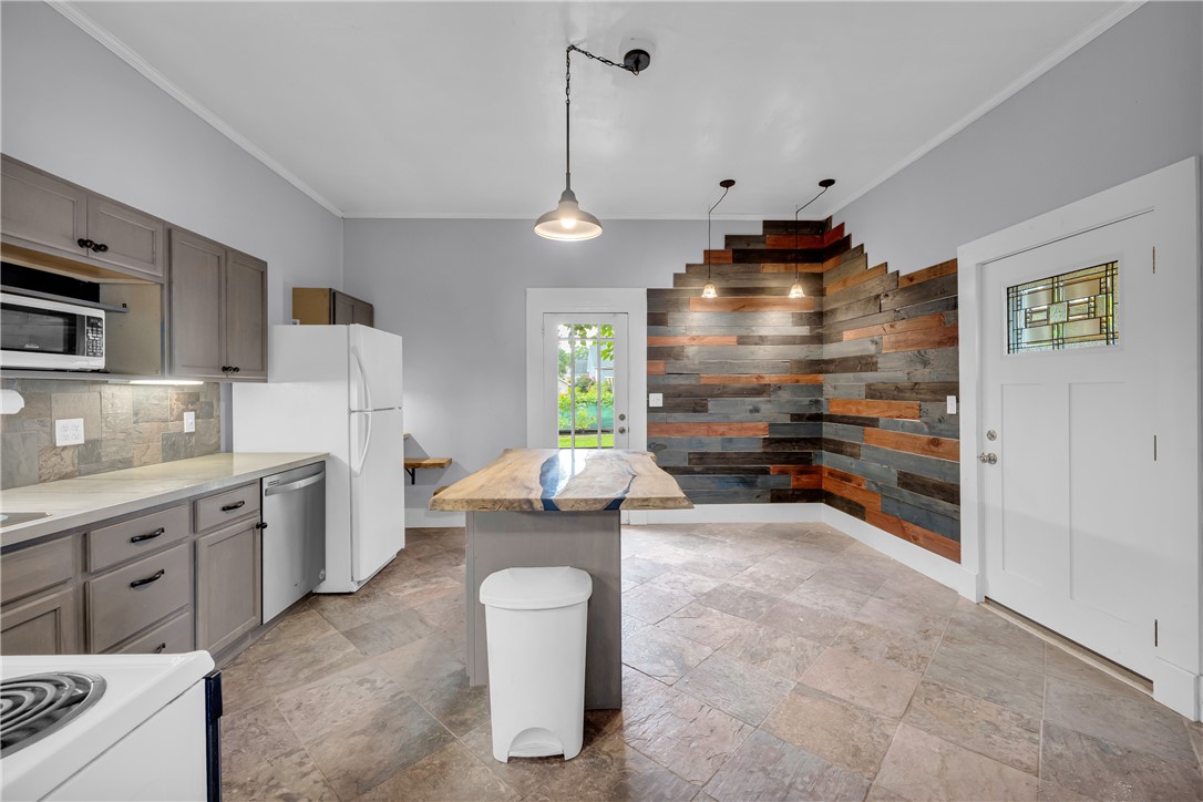 308 Verner Street Walhalla, SC 29691 - Photo 9 of 49 Rich wood plank accents and tile flooring bring warmth to this thoughtfully designed kitchen space.