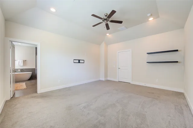 a view of a livingroom with a ceiling fan and couch