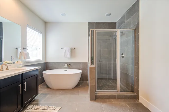a spacious bathroom with a double vanity sink mirror and shower