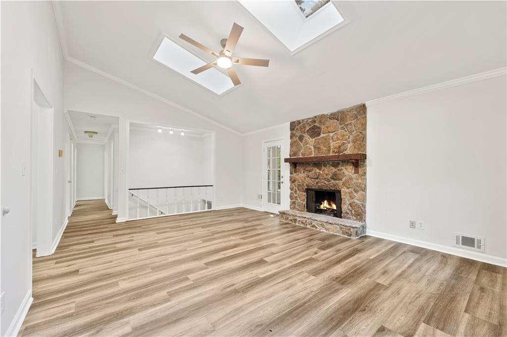 819 Gardenia Lane Decatur, GA 30033 - Photo 15 of 41 a view of a livingroom with a fireplace a ceiling fan and wooden floor