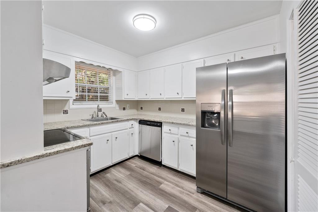 819 Gardenia Lane Decatur, GA 30033 - Photo 22 of 41 a kitchen with a sink cabinets stainless steel appliances and a window