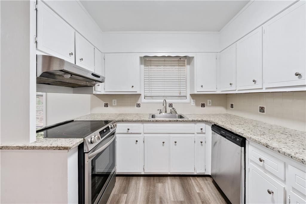 819 Gardenia Lane Decatur, GA 30033 - Photo 23 of 41 a kitchen with granite countertop a sink stove and cabinets