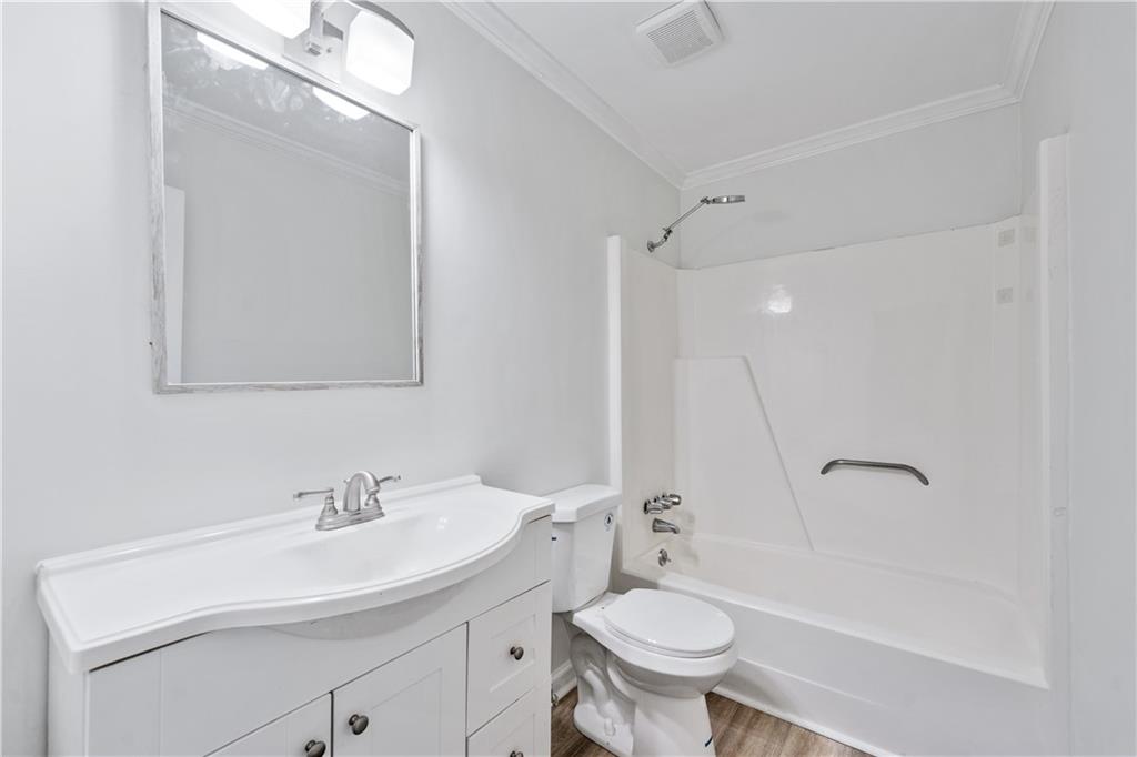 819 Gardenia Lane Decatur, GA 30033 - Photo 27 of 41 a bathroom with a sink toilet a mirror and shower