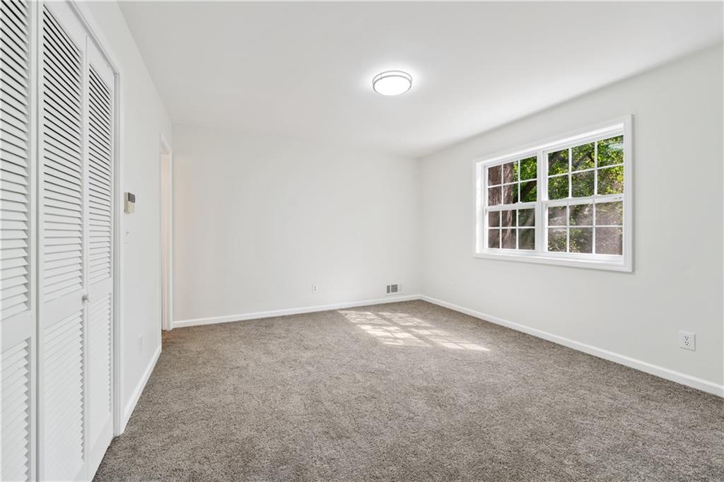 819 Gardenia Lane Decatur, GA 30033 - Photo 28 of 41 an empty room with windows