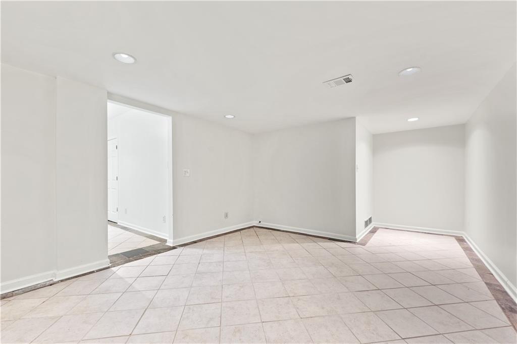 819 Gardenia Lane Decatur, GA 30033 - Photo 31 of 41 an empty room with white walls and tiles