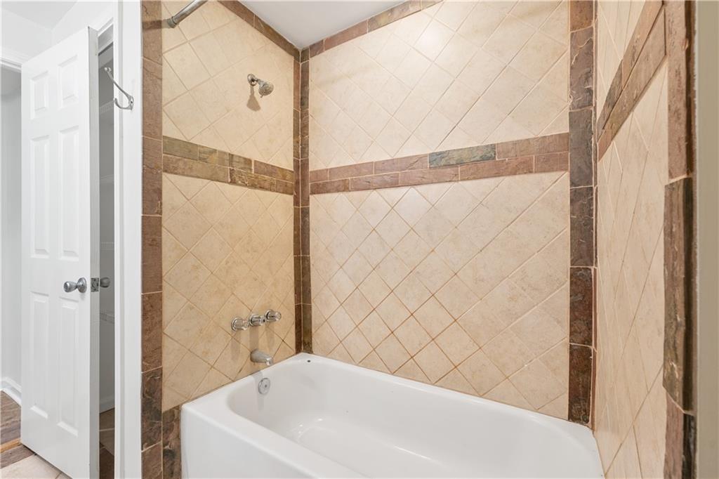 819 Gardenia Lane Decatur, GA 30033 - Photo 35 of 41 a bathroom with a bathtub and a shower