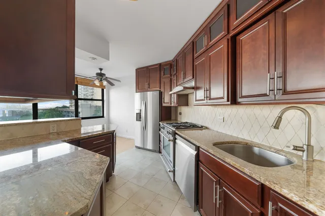 a living room with a large window and chandelier