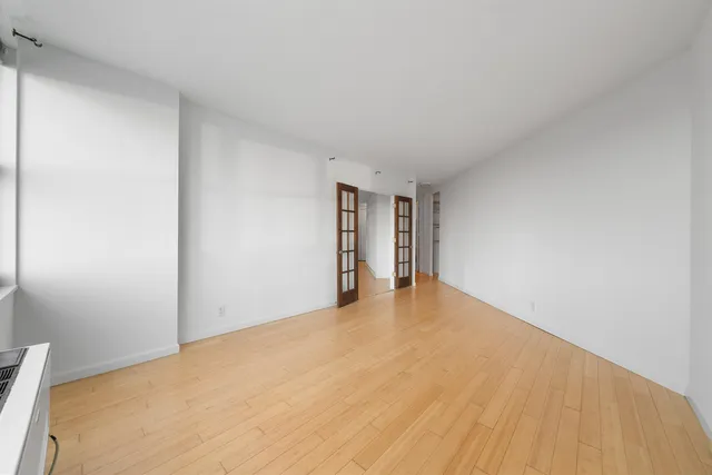 a view of an empty room and wooden floor