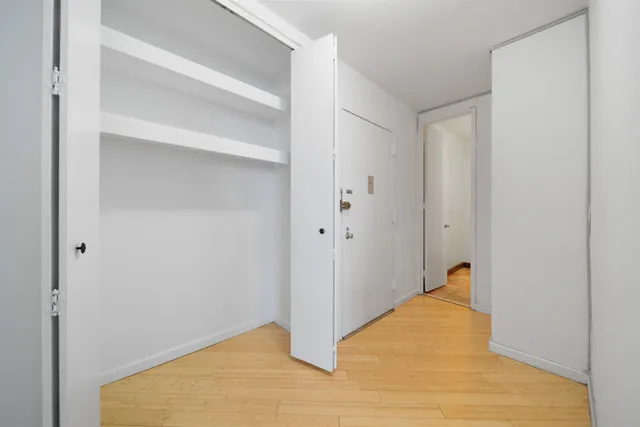 a bathroom with a granite countertop toilet sink and mirror