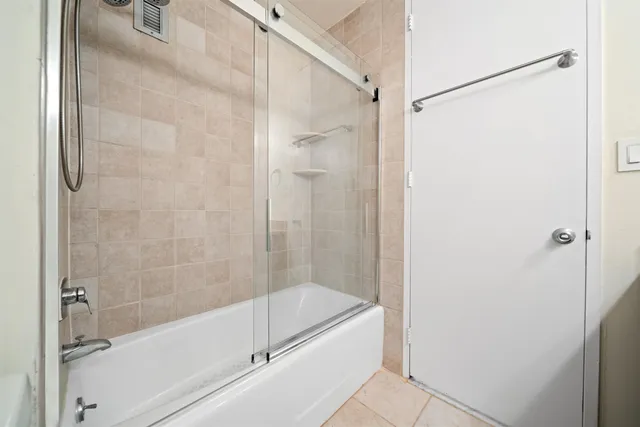 a bathroom with a granite countertop sink and a toilet