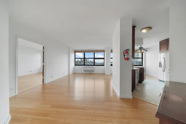 a view of a kitchen with a sink and a refrigerator