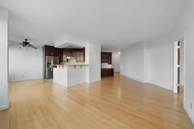 a view of a kitchen with a sink and a refrigerator