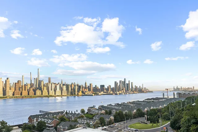 a view of a kitchen with a sink and refrigerator