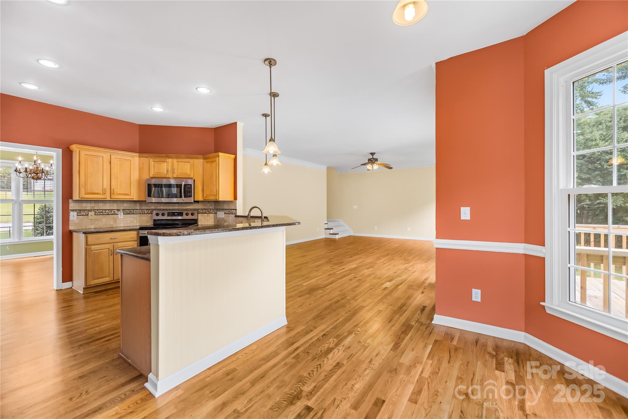 17112 Cambridge Grove Drive Huntersville, NC 28078 - Photo 14 of 44 a kitchen with stainless steel appliances granite countertop a refrigerator a stove and a wooden floors