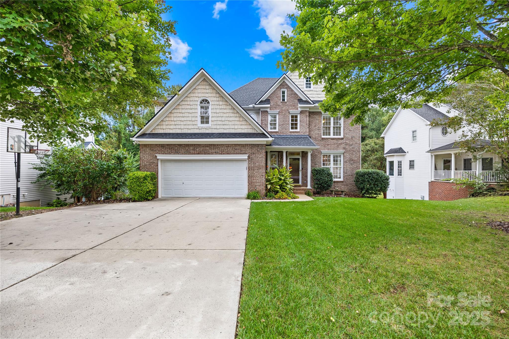 17112 Cambridge Grove Drive Huntersville, NC 28078 - Photo 2 of 44 a front view of a house with a yard and trees