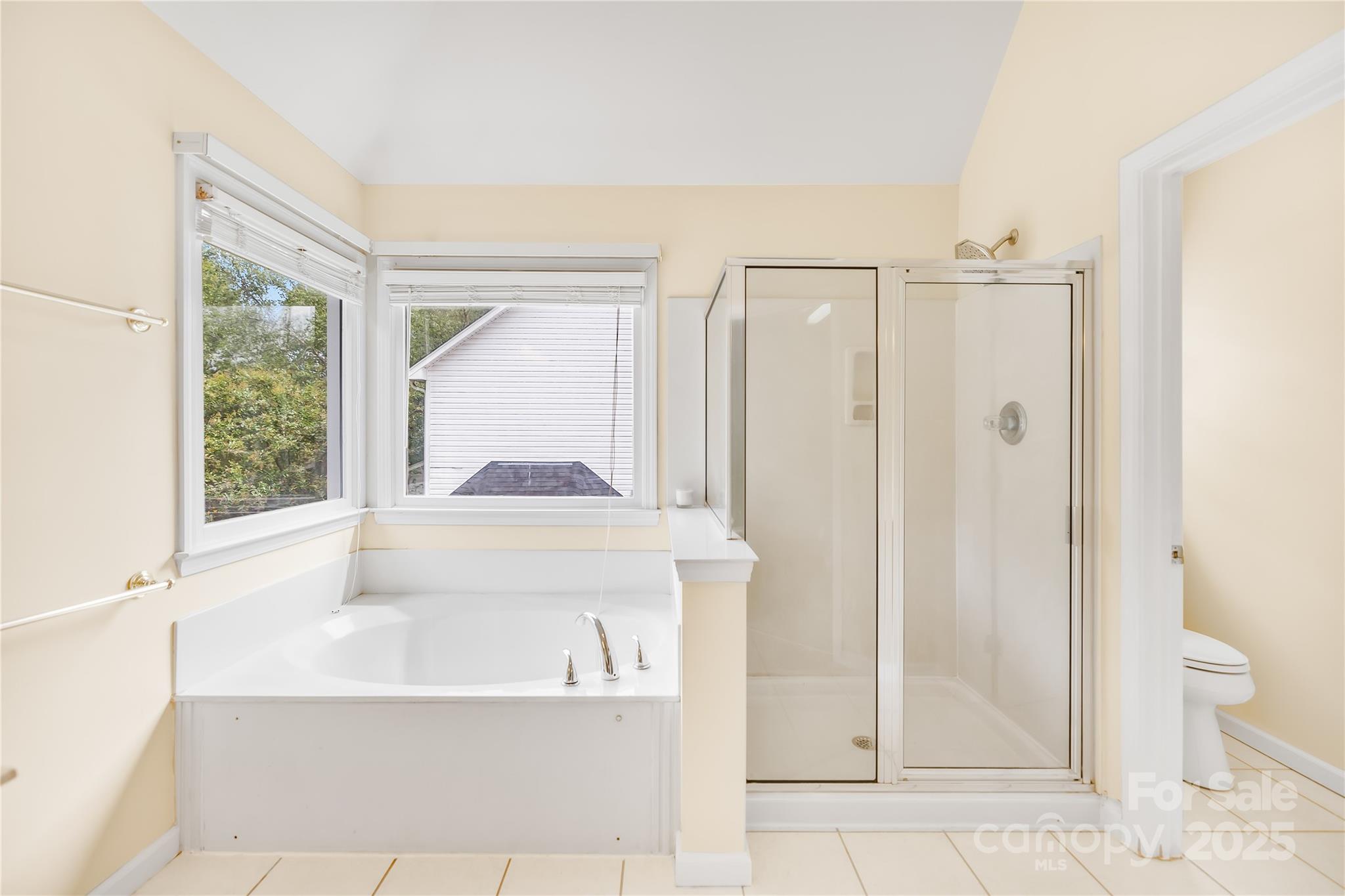 17112 Cambridge Grove Drive Huntersville, NC 28078 - Photo 21 of 44 a bathroom with a bathtub and a shower