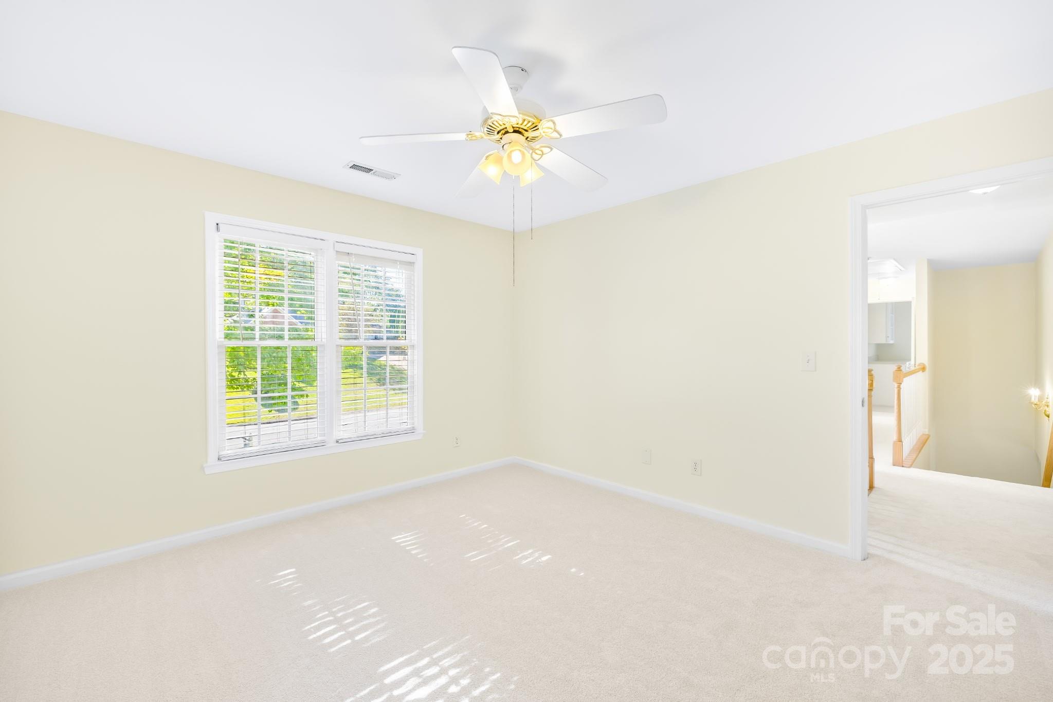 17112 Cambridge Grove Drive Huntersville, NC 28078 - Photo 25 of 44 an empty room with a window and a ceiling fan