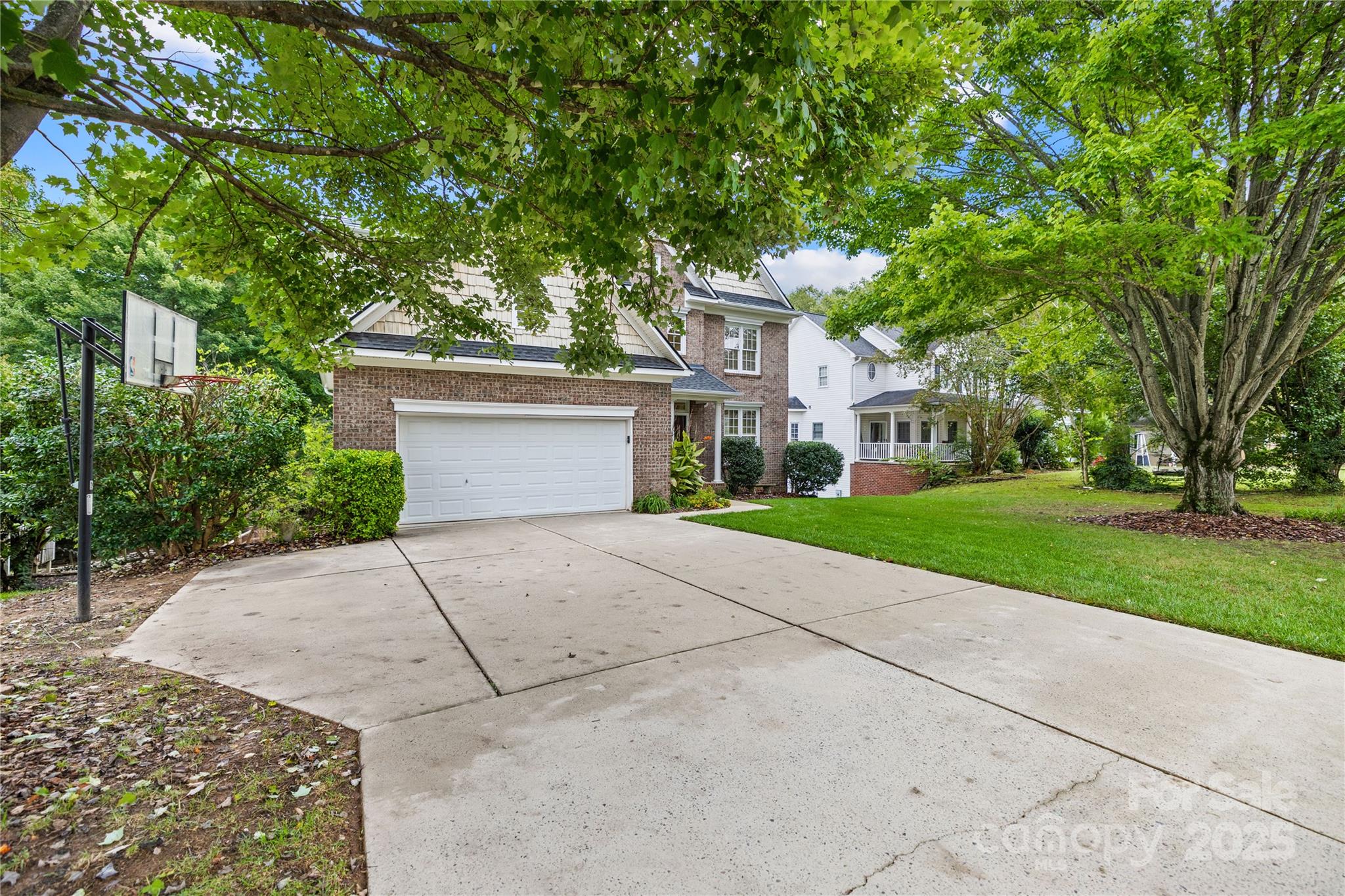 17112 Cambridge Grove Drive Huntersville, NC 28078 - Photo 3 of 44 a front view of a house with a yard and trees