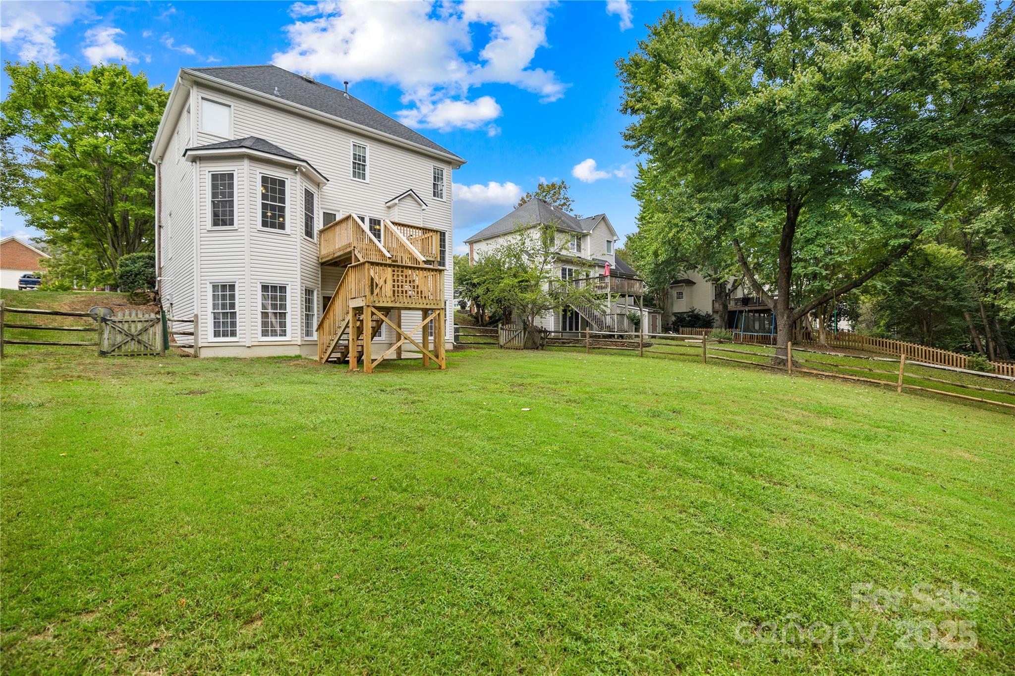 17112 Cambridge Grove Drive Huntersville, NC 28078 - Photo 36 of 44 a view of a white house with a big yard and large trees