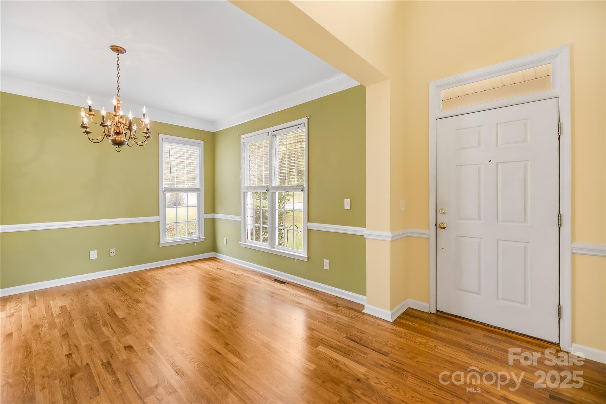 17112 Cambridge Grove Drive Huntersville, NC 28078 - Photo 4 of 44 a view of an empty room with chandelier and a window