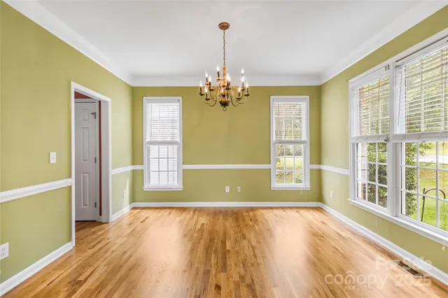 a view of a room with wooden floor and entryway