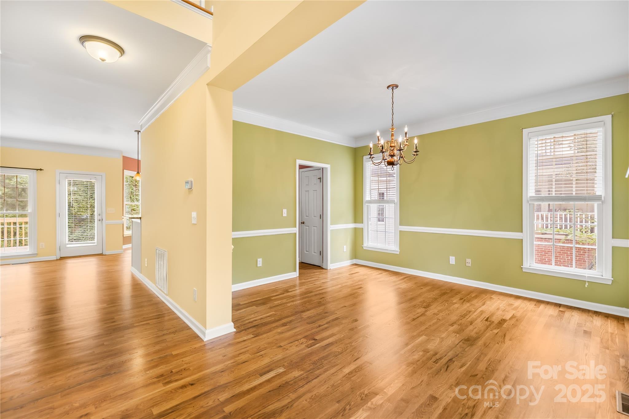 17112 Cambridge Grove Drive Huntersville, NC 28078 - Photo 6 of 44 a view of an empty room with window and wooden floor